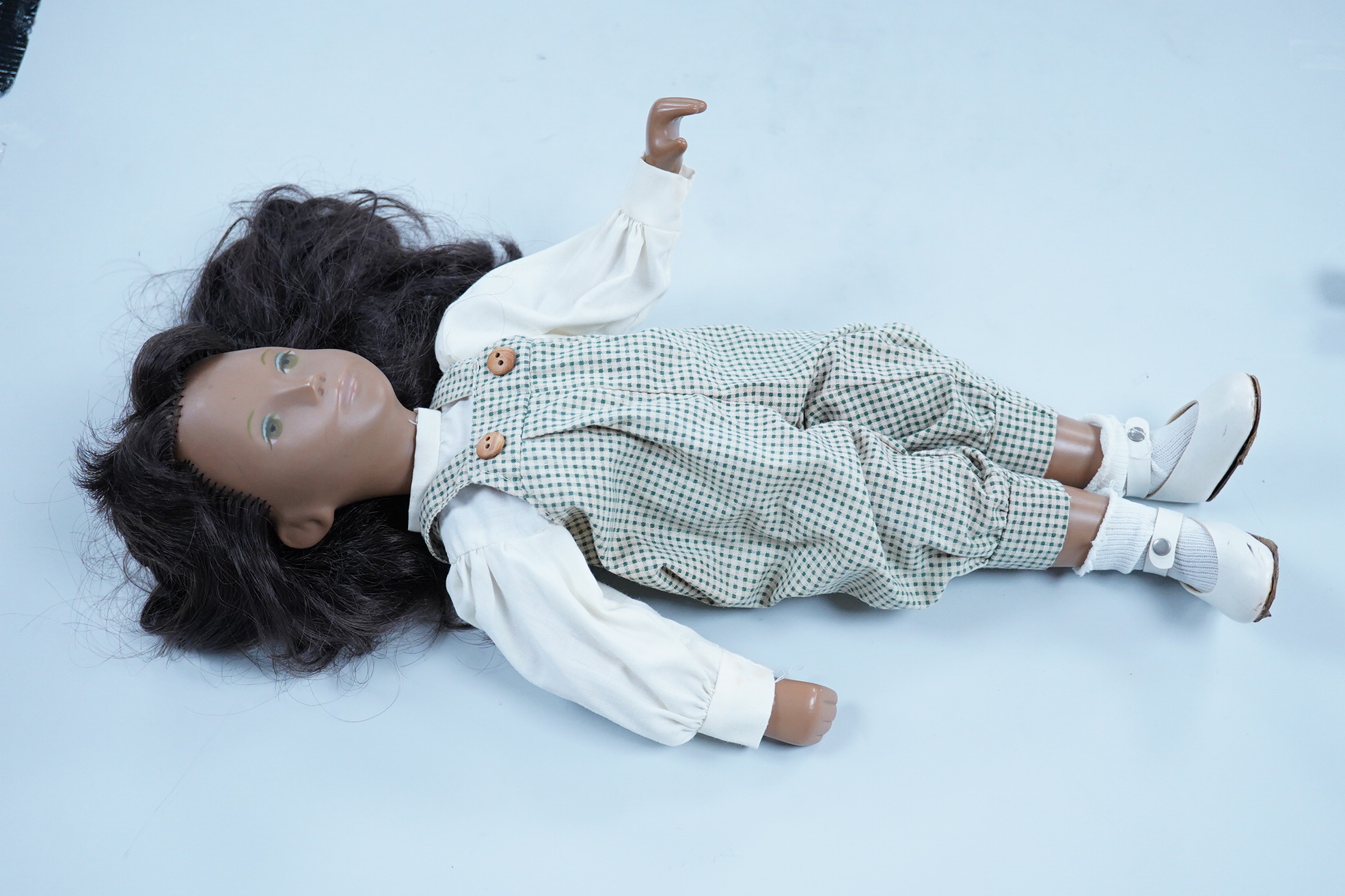 A Sasha Doll, 42cm high, with a selection of clothes, including some possible original commercially produced clothes together with other handmade clothes